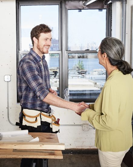 Carpenter shaking hands with client